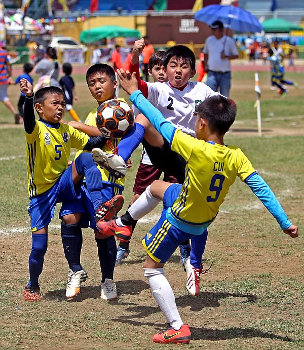 Don Bosco (yellow jersey) and Warshock Phoenix booters in action during their Thirsty Football Cup match. (CDN PHOTO/LITO TECSON)