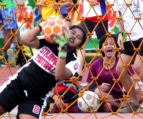 A supporter of team Sta. Barbara (background) celebrates this all-important save during her team’s match against Gerry's Restaurant and Bar last Friday in the 14th Thirsty Football Cup at the Cebu City Sports Sports Center pitch.  (CDN PHOTO/JUNJIE MENDOZA)