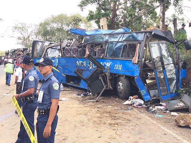 Police secure the accident area after the bus carrying students and teachers from Bestlink Colleges of the Philippines rammed a post in Tanay, Rizal. Fifteen people were killed in the accident last Monday. (INQUIRER PHOTO)
