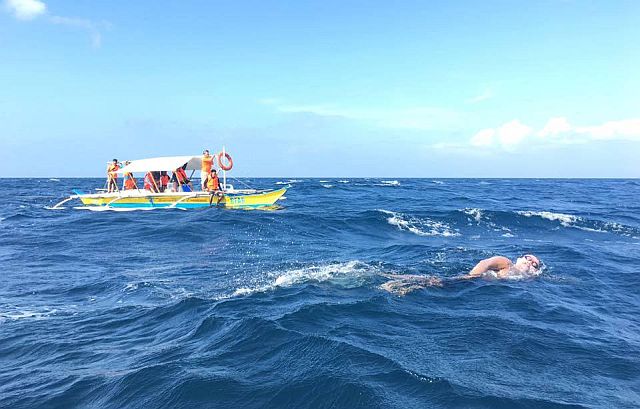 Support crew watches Ingemar Macarine brave the strong current and big waves in his 13-kilometer open-water swim from Limasawa Island to Padre burgos Port in Southern Leyte.