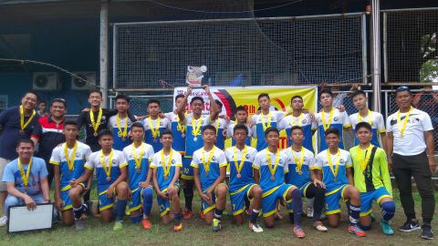 Don Bosco Technological College (DBTC) players show off their trophy and medals after they ruled the under-15 boys division of the 18th Aboitiz Football Cup at the DBTC football field./GLENDALE G. ROSAL