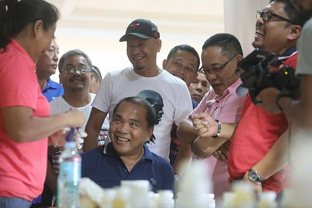 Suspended Ermita barangay captain Felicisimo "Emok" Rupinta cracks some jokes as his urine samples were being tested for traces of drugs. The testing was supervised by Councilor Dave Tumulak (pink shirt) and ABC president Philip Zafra (red shirt). (CDN PHOTO/TONEE DESPOJO)
