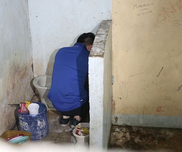 David Lim Jr. tries to hide an emotional moment at the toilet area of his detention cell.