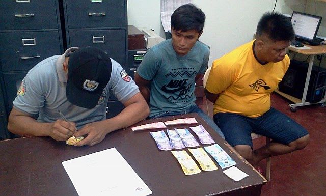 Remerl Pojas, 20, of Duljo Fatima, Cebu City (blue shirt) and inmate Fernando Pagobo, 37, of Gun-ob, Lapu-Lapu City  (yellow shirt) were arrested for transporting illegal drugs. (CDN PHOTO/NORMAN MENDOZA)