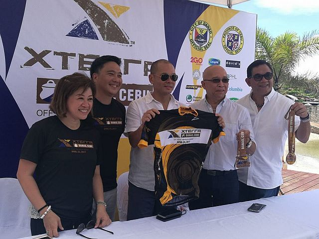 Princess Galura (left to right) of Sunrise Events; Mark Tolentino, Provincial Administrator; Congressman Red Durano; Danny Roble, Danao Tourism Officer; and Dr. Peter Mancao, Xterra Danao Medical Director, show the race jersey and medals for the upcoming Xterra Philippines, which will be held on April 23 in Danao City, northern Cebu. (CDN PHOTO/CHRISTIAN MANINGO)