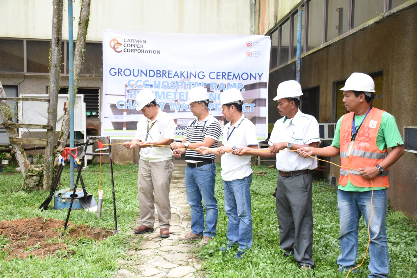 Officials of Carmen Copper Corp. (CCC) led by Ignacio Alburo, assistant vice president for general services of CCC, lay  the time capsule during the groundbreaking ceremony of the construction of a CCC hospital ramp and perimeter fence project. contributed
