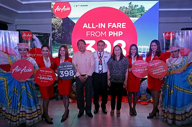 Tourism Regional Director Catalino Chan III (fourth from left) welcomes the opening of new direct AirAsia flight routes from Cebu to Davao, Palawan and Boracay via Caticlan. The new flight routes were announced by AirAsia officials led by its chief executive officer, Dexter Comendador (5th from left) on Monday in Cebu City. (CDN PHOTO/LITO TECSON)