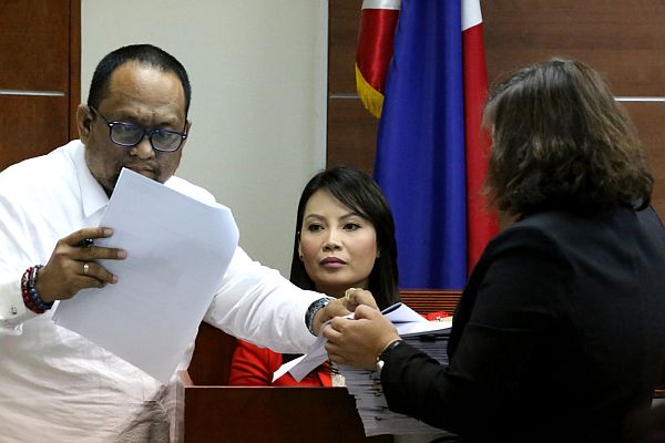 SM SEASIDE VS CEBU CITY. Michelle Llanos (center on the witness stand), SM Prime Holding’s vice president for operation in the Visayas, listens as Cebu City lawyer Carlo Vincent Gimena (left)  examines documents presented by Lawyer Crysilla Carissa P. Bautista (back to the camera), one of the legal counsels of SM Prime, during the hearing of the petition for mandamus and prohibition filed by SM Seaside against the Cebu City government and heard at the sala of Cebu Regional Trial Court Branch 9  Judge Alexander Nicandro V. Acosta on March 9, 2017. CDN PHOTO/JUNJIE MENDOZA