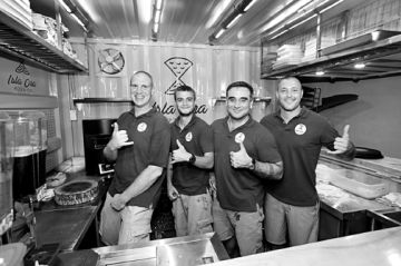 These are the people behind Isla Ora Pizza Co. They are  Erik Roen, executive chef; Arin White, vice president for operations; Captain Joseph Ferris III, president; and Christopher White, CEO.