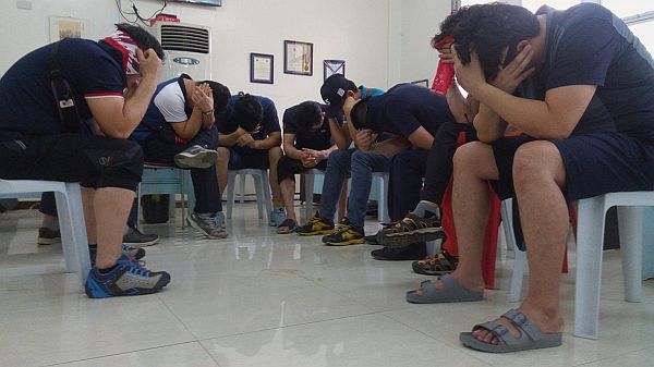 BOWED HEADS.   These Korean tourists accused of engaging in a sex tour cover their faces when presented to the media at the National Bureau of Investigation in Central Visayas (NBI-7) office in Cebu City following their arrest on Saturday, March 4, 2017.