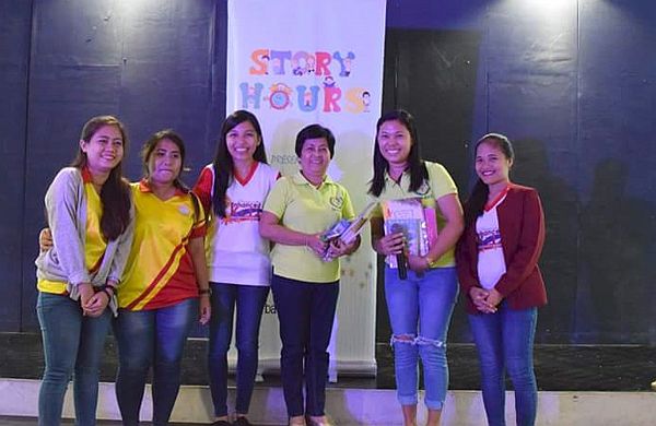 Teacher Lyra Jayoma (second from right) of Mactan Air Base Elementary School receives  books from teachers of Sto. Niño Mactan Montessori School. Private school pupils are encouraged to bring books to be donated to their public school partner as part of Story Hours.  PHOTO VIANCA ABELLANA