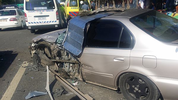   A silver Honda Sedan blocks the road near the Mactan Export Processing Zone along Barangay Pusok, Lapu-Lapu City after a head-on collision with a Toyota Innova that turned turtle twice. Witnesses said it was a miracle that no one was badly injured in the incident.  Edison delos Angeles