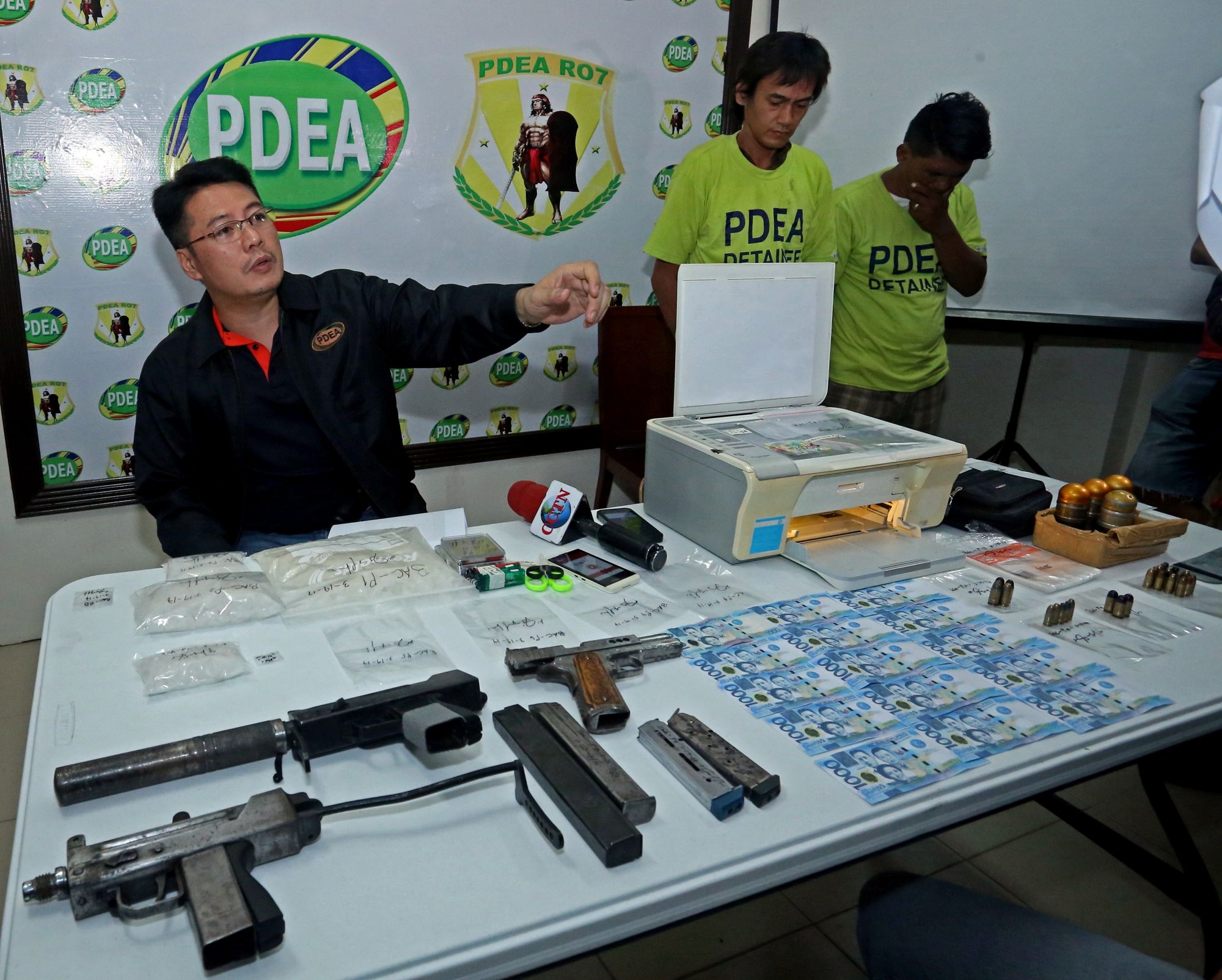 Philippine Drug Enforcement Agency (PDEA-7)  Regional Director Yogi Filemon Ruiz presents to the media arresteddrug suspects Roy Cañon and Erwin Abellana, both of whom are said to be cohorts of alleged drug lord 25-year-old Joshua Bucog. CDN PHOTO/LITO TECSON