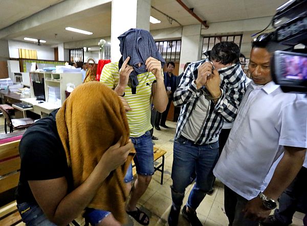 The three Romanian suspects covered their faces to avoid the glare of cameras at the Cebu City Prosecutor’s Office (above) even as police uncover yet another vehicle (CDN FILE PHOTO)