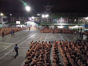 This photo from the Cebu Provincial Police Office (CPPO) taken on February 28, 2017, and released on March 2, 2017, shows naked inmates at the Cebu Provincial Detention and Rehabilitation Center sitting in rows at the quadrangle during a joint raid by the Philippine Drug Enforcement Agency and the CPPO. Merlie DACUNOS /CEBU PROVINCIAL POLICE OFFICE / AFP 