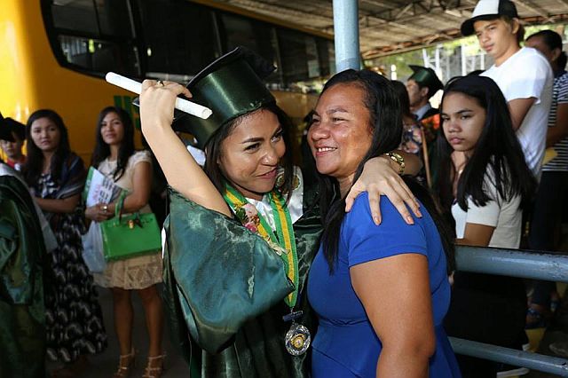 Triumphant graduate, Regine Villamejor hugs her proud mother, Mary Jane, after the graduation rites. (CDN PHOTO/JUNJIE MENDOZA)
