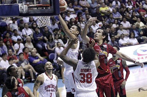 Ginebra’s Japeth Aguilar and Joe Devance try to secure a rebound against San Miguel’s June Mar Fajardo in Game 5 of the Finals at the Araneta Coliseum. pba.ph