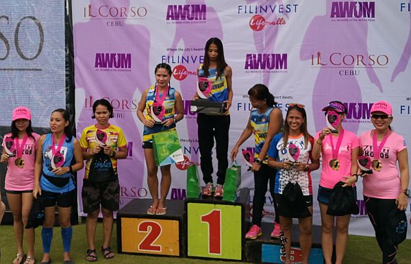 Led by champion Izane Abella (center), top finishers in yesterday’s 6th All Women’s Ultra Marathon receive their plaques and medals during the awarding ceremony at Il Corso grounds at the South Road Properties, Cebu  City. CDN PHOTO/CHRISTIAN MANINGO