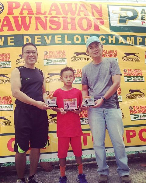 Chad Connor Cuizon (center) shows off the awards he won in the Palawan Pawnshop-Palawan Express Pera Padala (PPS-PEPP) regional tennis tournament in the City of La Carlota in Negros Occidental. contributed