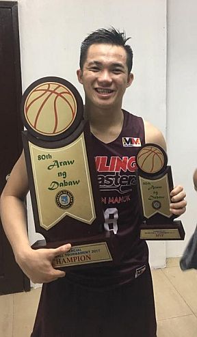 Desiderio shows off the championship and MVP trophies after leading UP to the Araw ng Davao hoops crown. contributed