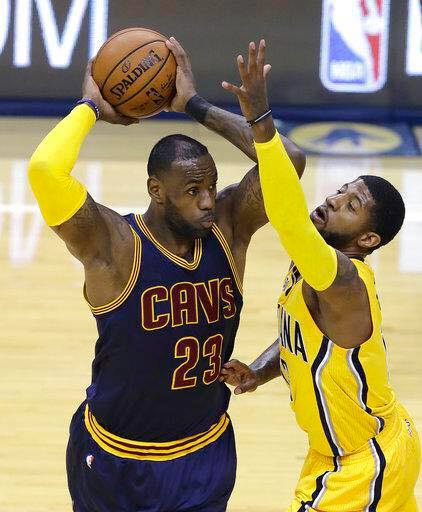 Cleveland's LeBron James guarded by Paul George of Indiana/  Ap 