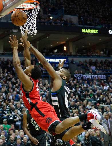 Milwaukee Bucks' Greg Monroe blocks the shot of Toronto Raptors' Kyle Lowry during the first half of game 3 of their NBA first-round playoffs / AP