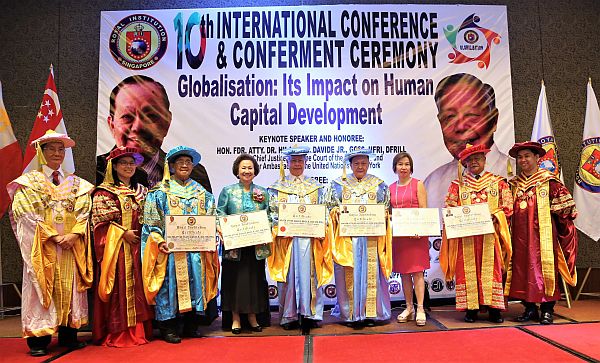 Former Chief Justice Hilario Davide Jr. (5th from left) and lawyer Augusto Go (6th from left)  are conferred honorary doctorate titles by the Royal Institution Singapore (RIS) during its 10th International Conference and Conferment Ceremony last April 8 at the Marco Polo Plaza Cebu. With them are RIS officials led by Dr. Molano (2nd from left).  CONTRIBUTED PHOTO