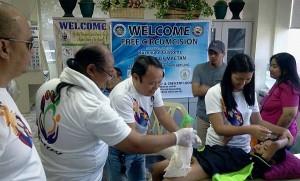 Bureau of Customs Sub-Port of Mactan collector Gerry Campo (middle) and colleagues assist in circumcising one of almost 200 beneficiaries from three barangays in Lapu-Lapu City.