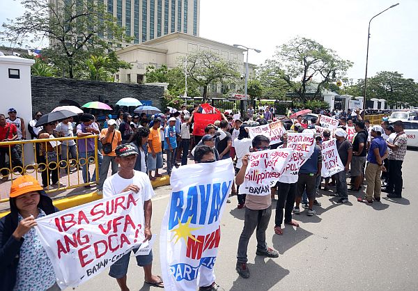 Members of left wing Bayan Muna staged a rally on Wednesday in front of one of the venues for the  Association of Southeast Asian Nations (Asean) meetings in Cebu to oppose closer cooperation between the Philippines and China,  and the United States of America.  CDN PHOTO/LITO TECSON