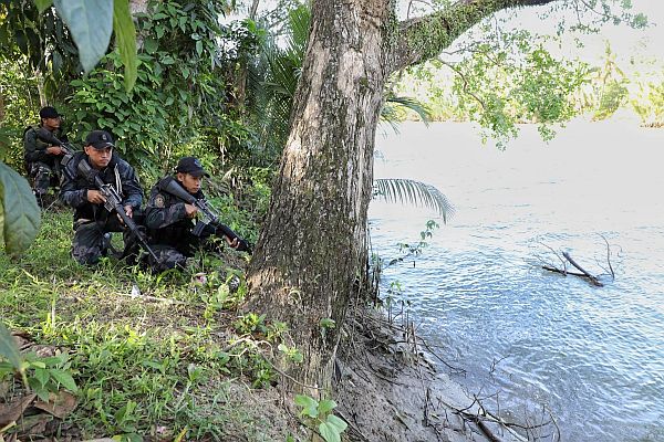 Elements of  Regional Public Safety Battalion secure the Inabanga River used by suspected Abu Sayyaf rebels to enter Barangay Napo.