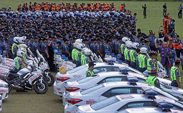 A police chaplain blesses the hundreds of security personnel who will be deployed beginning today (Monday) for the weeklong Asean summit meetings in a send-off ceremony held at Mactan Benito Ebuen Airbase.  CDN PHOTO/TONEE DESPOJO