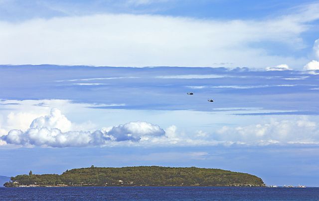 Two  military helicopters hover over Sumilon Island in Oslob town in southern Cebu as part of the Armed Forces’ security measures implemented in Central Visayas following the clash in Inabanga, Bohol,  on Tuesday that foiled  the entry of the Abu Sayyaf Group in Bohol.  (CDN PHOTO/TONEE DESPOJO)