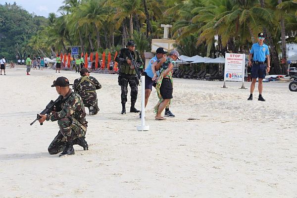 The Philippine Navy, Army, Coast Guard, National Police Maritime Group and local security forces simulate their law enforcement response in case of a terrorist attack on Boracay Island, on Monday.  /Inquirer photo 