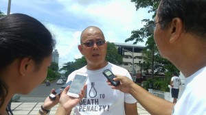 Fr. Robert Reyes is interviewed by reporters about his reaction on the trees that will be affected by the BRT project. cdn photo/michelle joy l. padayhag 