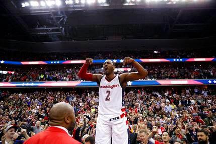 Washington Wizards guard John Wall celebrates as he stands on the scorer's table after Game 6 against the Boston Celtics in an NBA basketball second-round playoff series in Washington. Wall sank the game-winning 3-point shot. The Wizards won 92-91. AP Photo