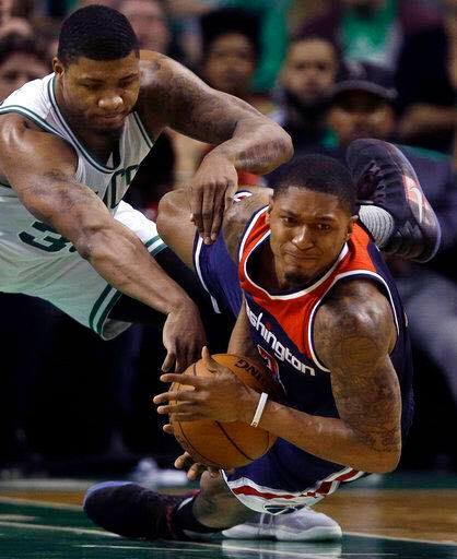 Washington Wizards guard Bradley Beal, right, goes down with the ball as Boston Celtics guard Marcus Smart defends during the second quarter of Game 7 of a second-round NBA basketball playoff series./AP