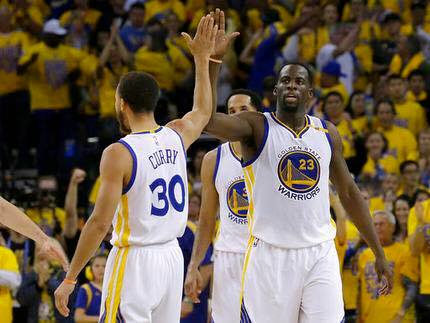 The Warriors' Steph Curry and Draymond Green exchange high fives in Game 1 of the Western Conference Finals. /Ap