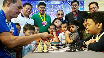 Philippine Sports Commission (PSC) Commissioner Ramon Fernandez (left) does the ceremonial opening move with Jerish John Velarde in the 2017 National Age Group Chess Championships Grand Finals, which started yesterday at Robinsons Galleria Cebu. 