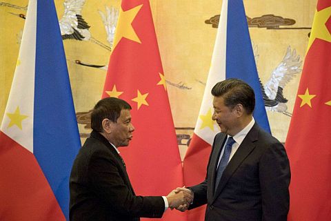 Philippine President Rodrigo Duterte (left) and his Chinese counterpart Xi Jinping shake hands after a signing ceremony in Beijing on October 20, 2016. Duterte is back in China for the Belt and Road Forum, May 14, 2017.  AFP FILE