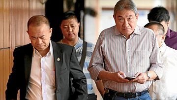  Alexander Wongchuking, Mighty Corp. president, (right) arrives at the National Bureau of Investigation Office in Manila following the seizure of P2 billion worth of Mighty cigarette packs with fake stamps in the company’s warehouse in Pampanga in this March 8, 2017 file photo. INQUIRER FILE PHOTO