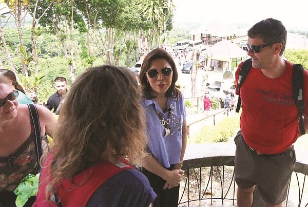 Department of Tourism (DOT) Secretary Wanda Corazon Teo interacts with tourists at the Chocolate Hills viewing deck in Carmen, Bohol.  (CONTRIBUTED PHOTO)