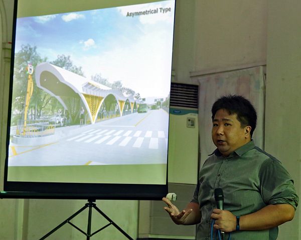 Atty. Rafael Yap, Bus Rapid Transit (BRT) project manager, presents a photo of a BRT asymmetrical type bus station during a public consultation on the P10-billion BRT project which will affect old trees standing within the BRT route.   CDN PHOTO/JUNJIE MENDOZA