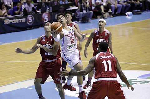 Cebuano RR Pogoy drives past the defense of Indonesia in the last game of the SEABA Championships at the Araneta Coliseum.