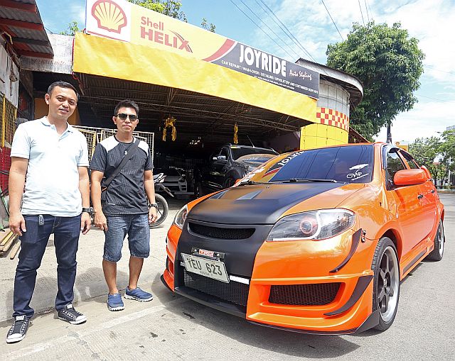 Joyride Auto Styling owner Leejibb Baring with his cousin Anthony Ignacio and his modified Toyota Vios at the shop. CDN PHOTO/LITO TECSON