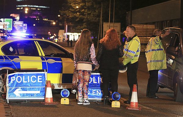 Police work at Manchester Arena after reports of an explosion at the venue during an Ariana Grande gig in Manchester, England. AP