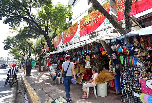 Vendors, who are part of the Sinulog Street fair in this January 2017 photo, sit in their stalls as they wait for customers to buy their wares. | CDN FILE PHOTO