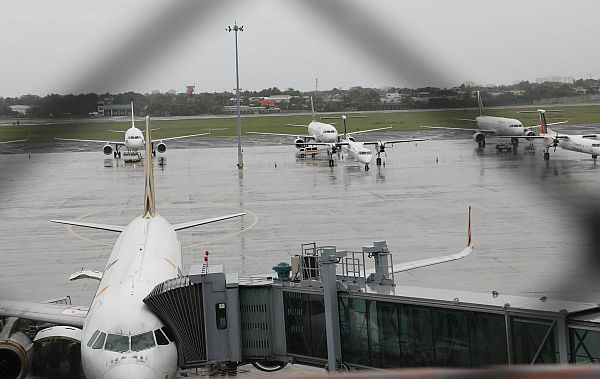 Airplanes remain parked at the Mactan-Cebu International Airport CDN PHOTO/TONEE DESPOJO