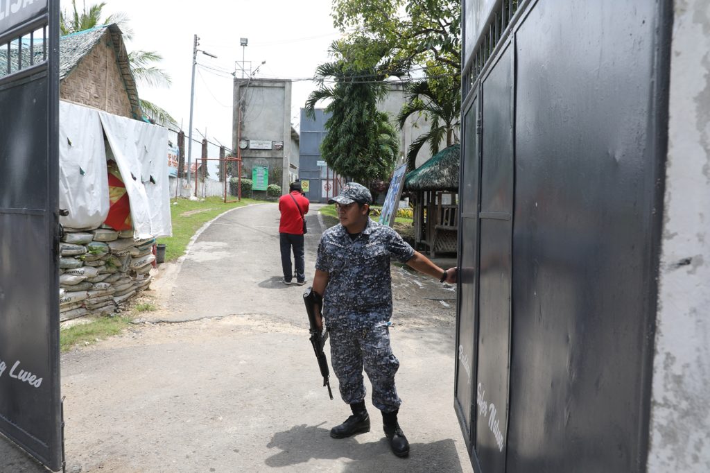 A Talisay City jail guard secures the gate of the Talisay City Jail Female Dormitory. The jail has suspended visiting rights of inmates relatives due to the coronavirus threat. | CDN Digital file photo
