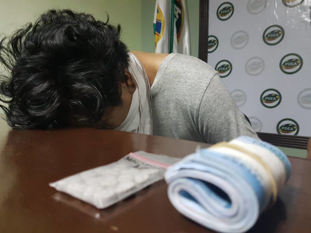 Elvin Joseph Laput, 24, hides his face on the table in shame