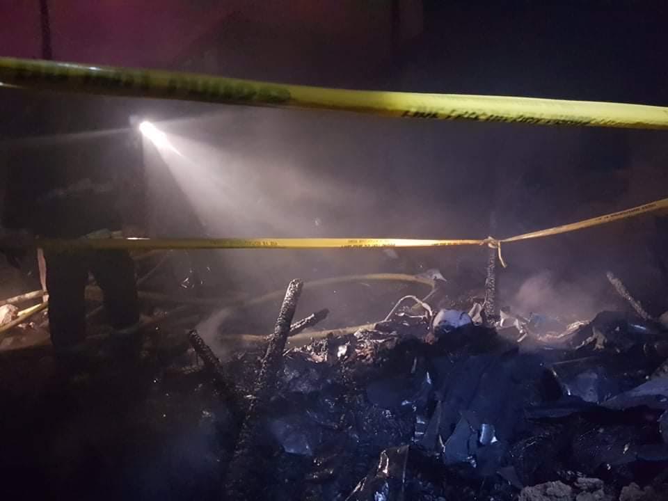 Police and fire authorities cordon an area where Mario Abella, 65, has died in a fire that hit his home and razed 9 other houses in Tres de Abril, Barangay Labangon, Cebu City at 2:32 a.m. of March 14, 2019. |CDND Photo by Benjie B. Talisic